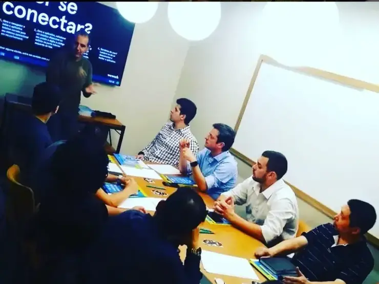 Roberto Calderon em sala de aula com uma turma de donos de empresa